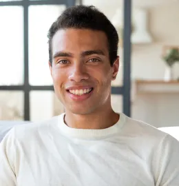 A young man smiling after his dental visit