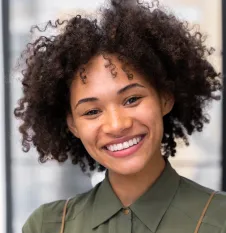 A woman smiling after her dental treatment