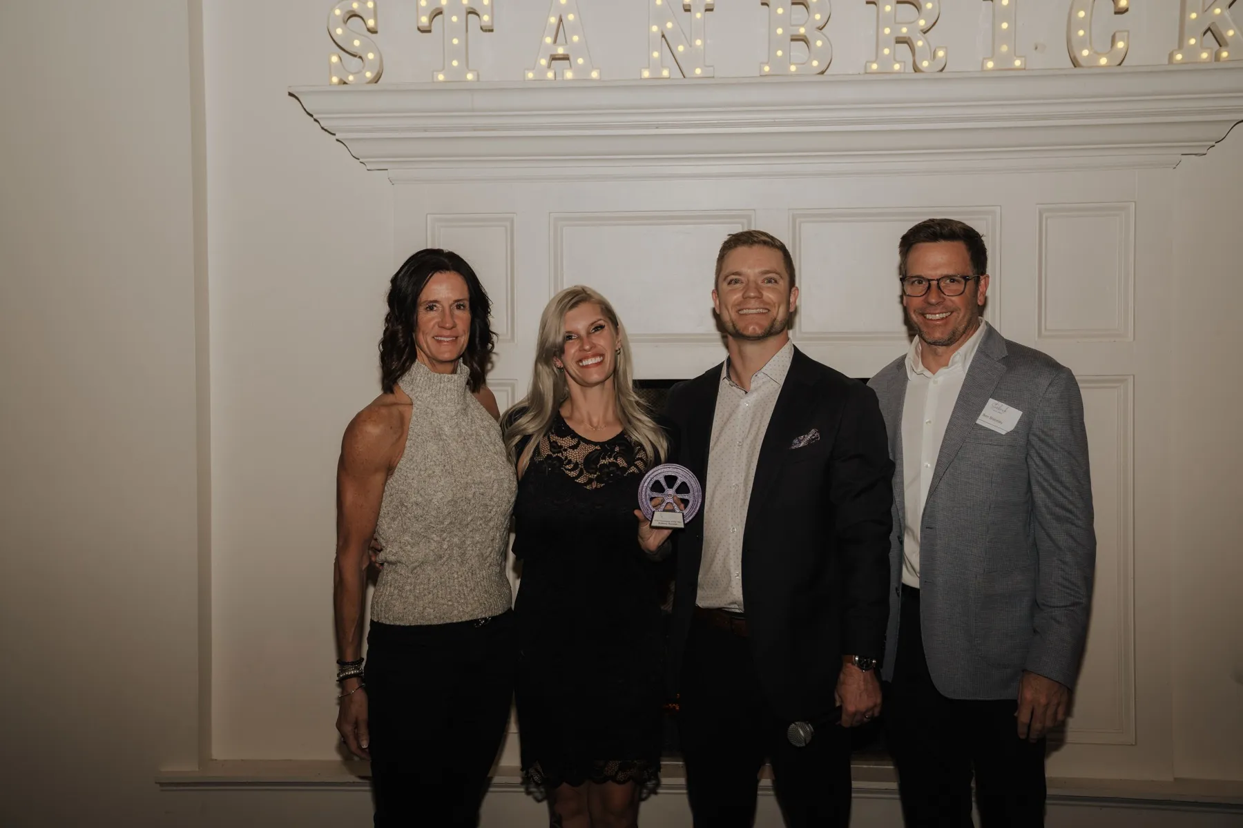 Colleagues celebrating an award winner at the Stanbrick holiday party
