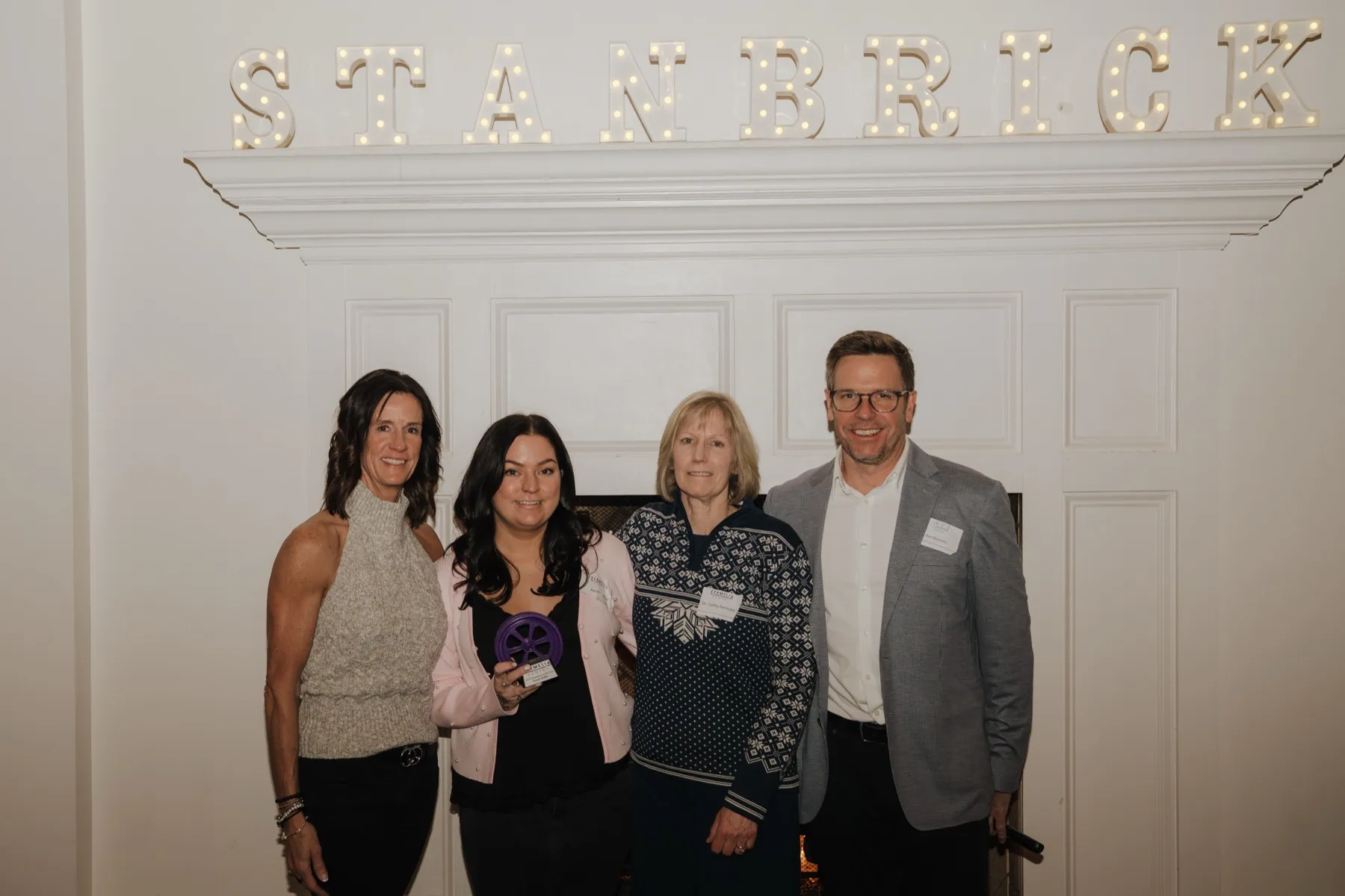 Four teammates together at the Stanbrick holiday party