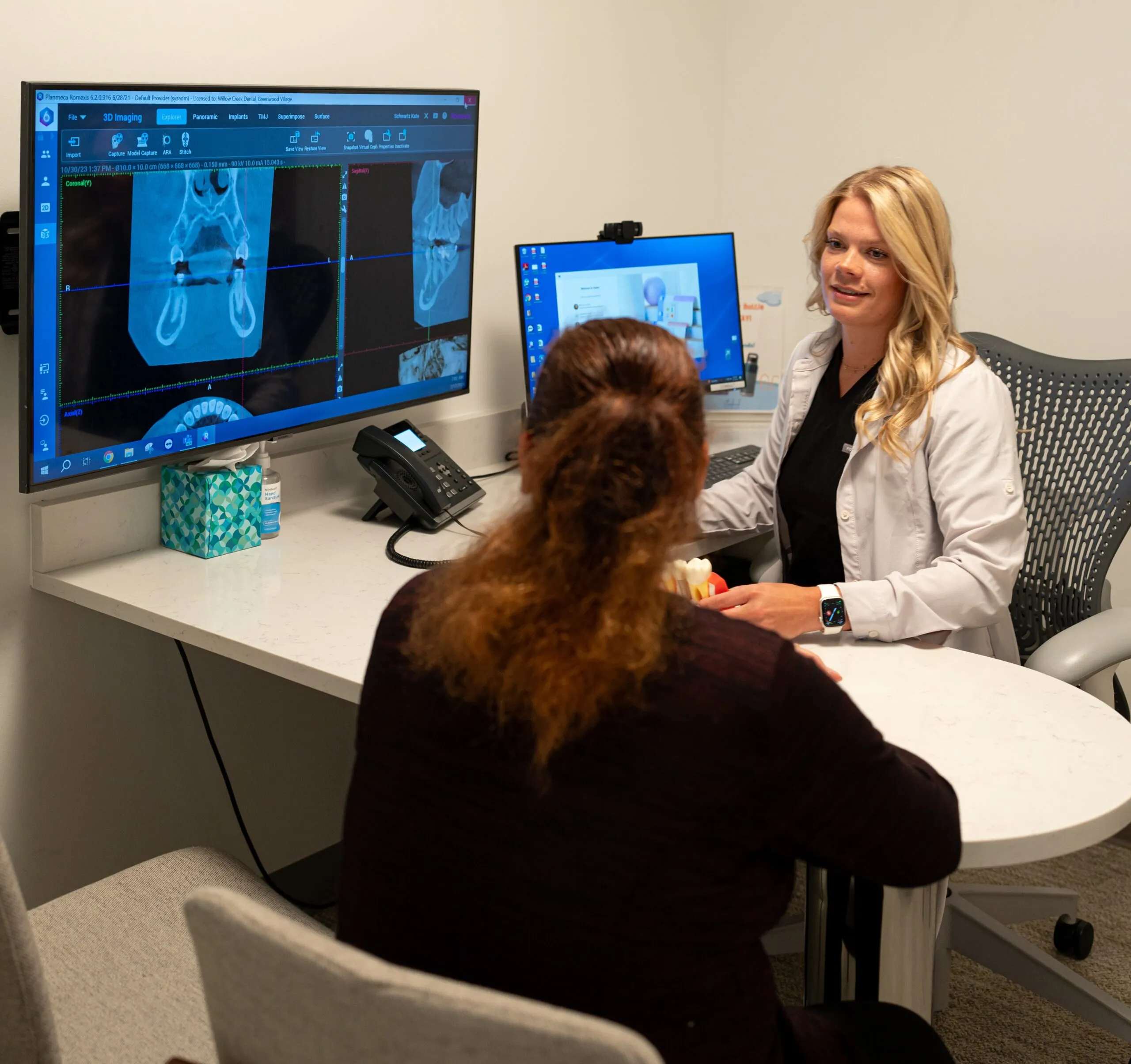 A Stanbrick dentist and patient reviewing imaging together in the consultation room