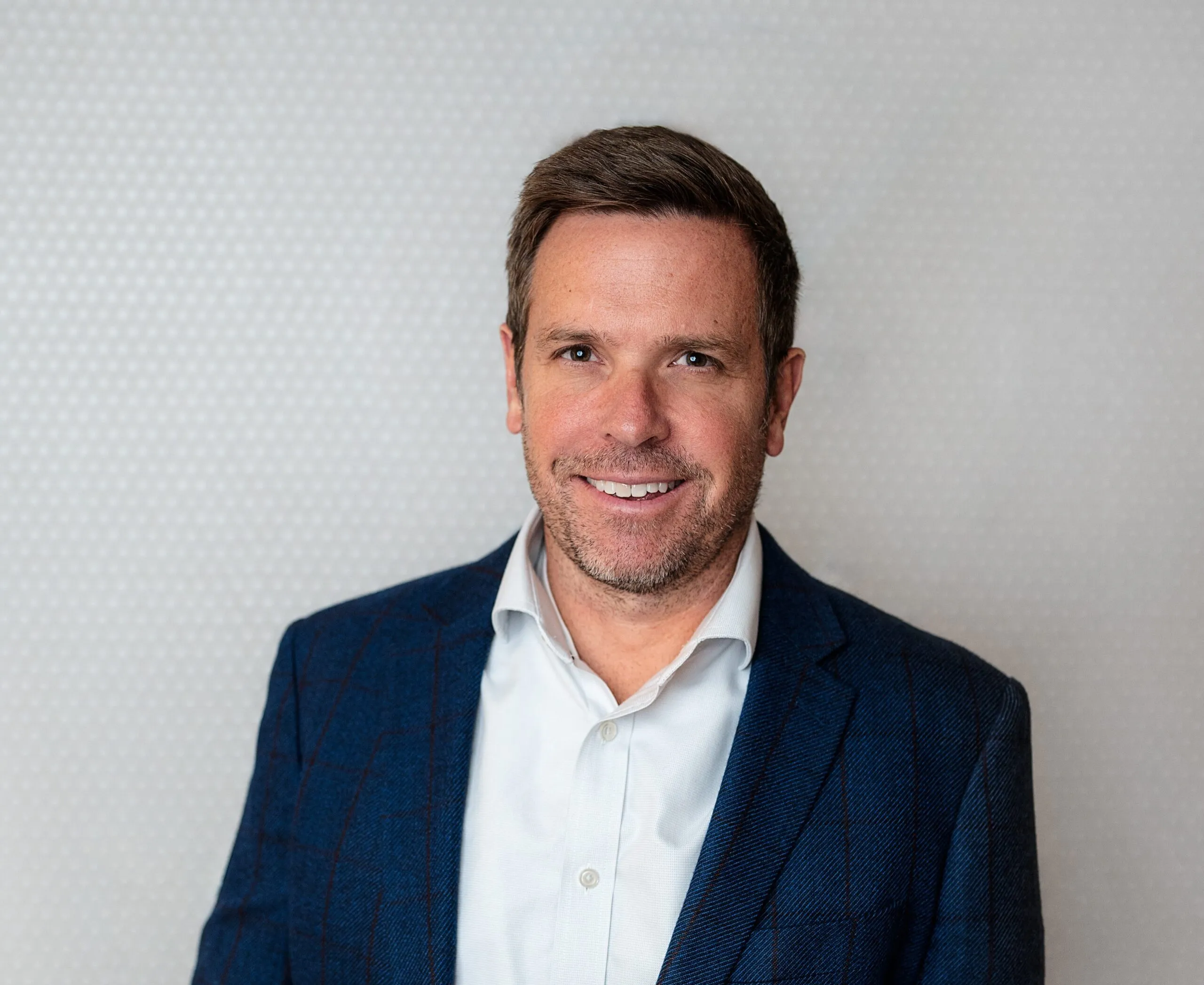 Ben Blakeley, Co-Founder and CEO, in a navy blazer